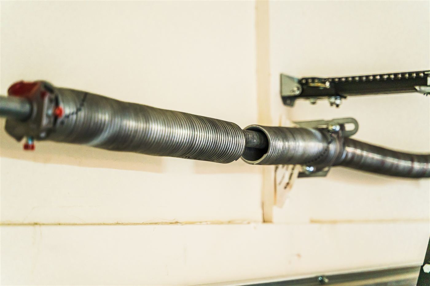 Broken garage door torsion spring with a visible gap