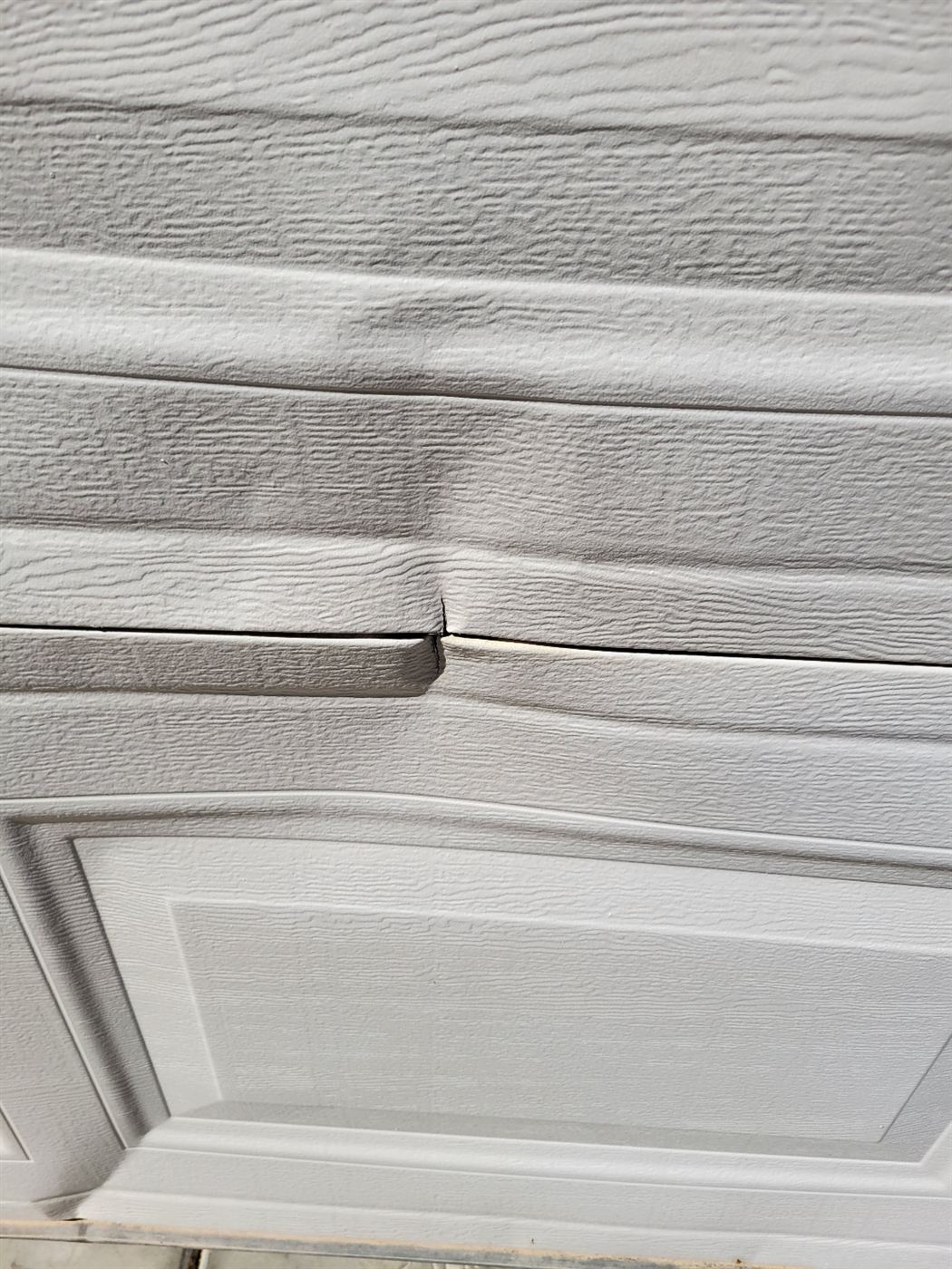 Dented bottom section on a garage door in San Tan Valley