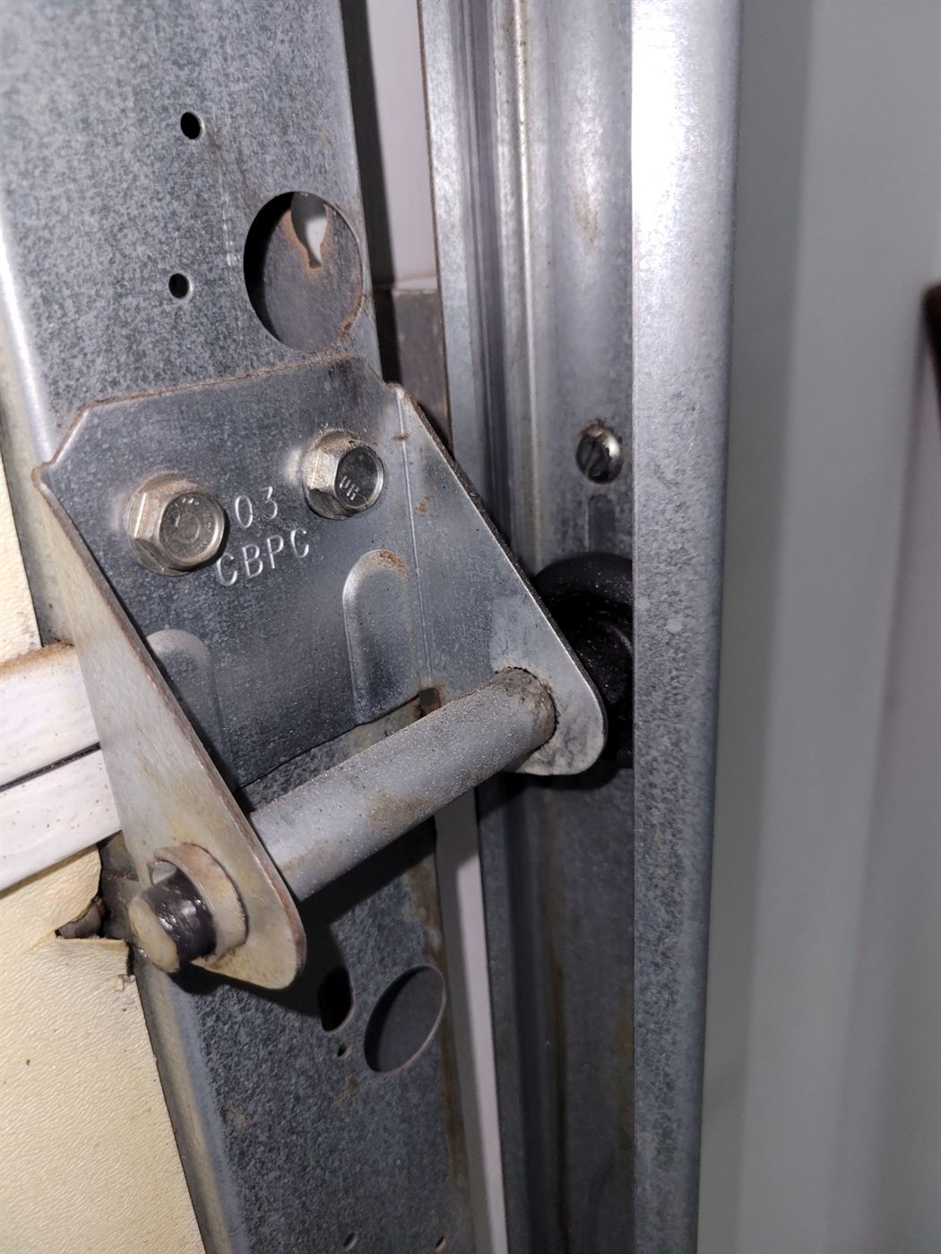 Garage door hinge and roller checked during a tune-up