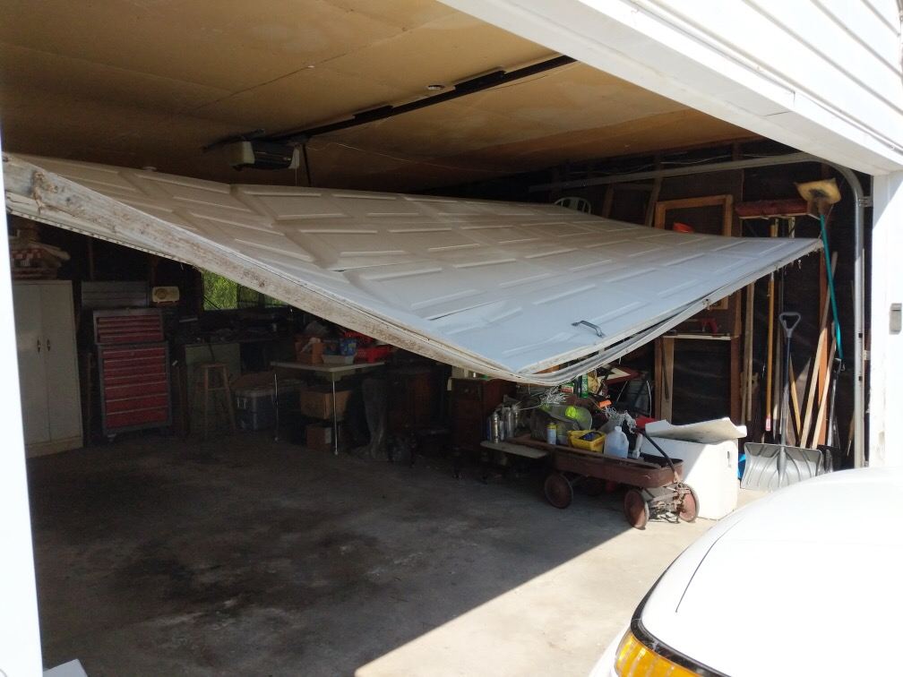 Garage door knocked off its tracks after being hit