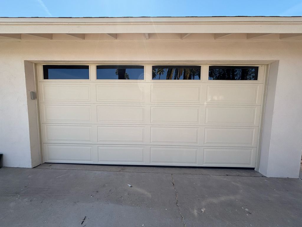 New raised-panel garage door with a window section